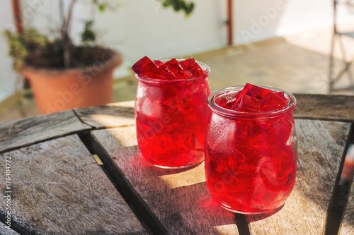 red jelly, cut into dice, inside two glasses of glass