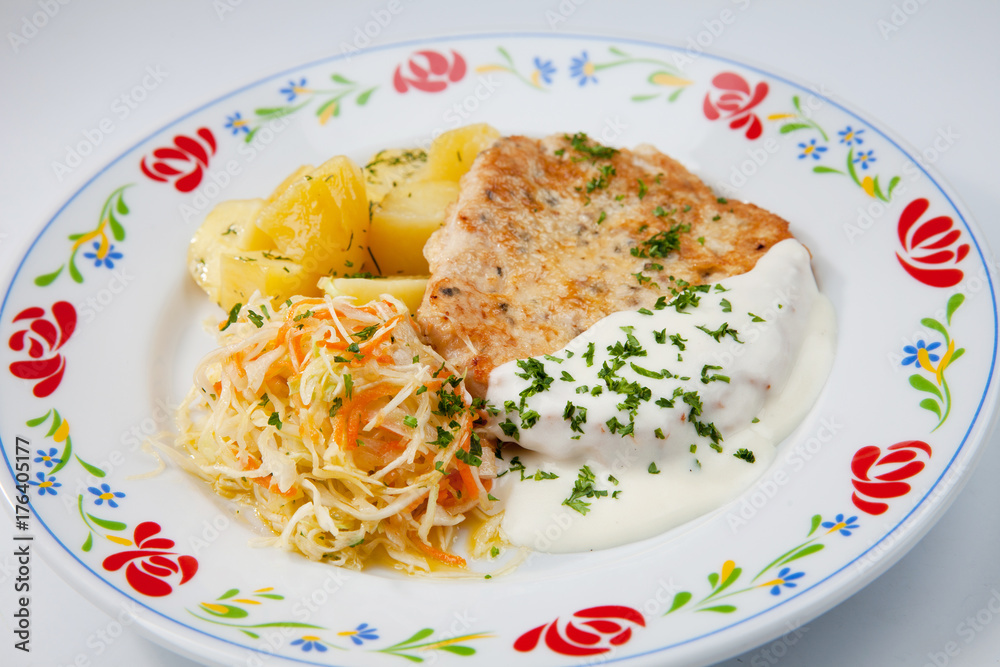 simple dish of Russian, Belarusian, Ukrainian cuisine on a white background Cutlets with potatoes and pickled cucumbers.. simple dish of Russian, Belarusian, Ukrainian cuisine on a white background Cutlets with potatoes and pickled cucumbers..