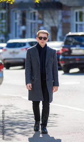Attractive blond young man outdoors in a city. Fashionable urban blogger. © vladhhe