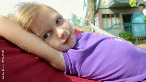 the child is resting on the hammock