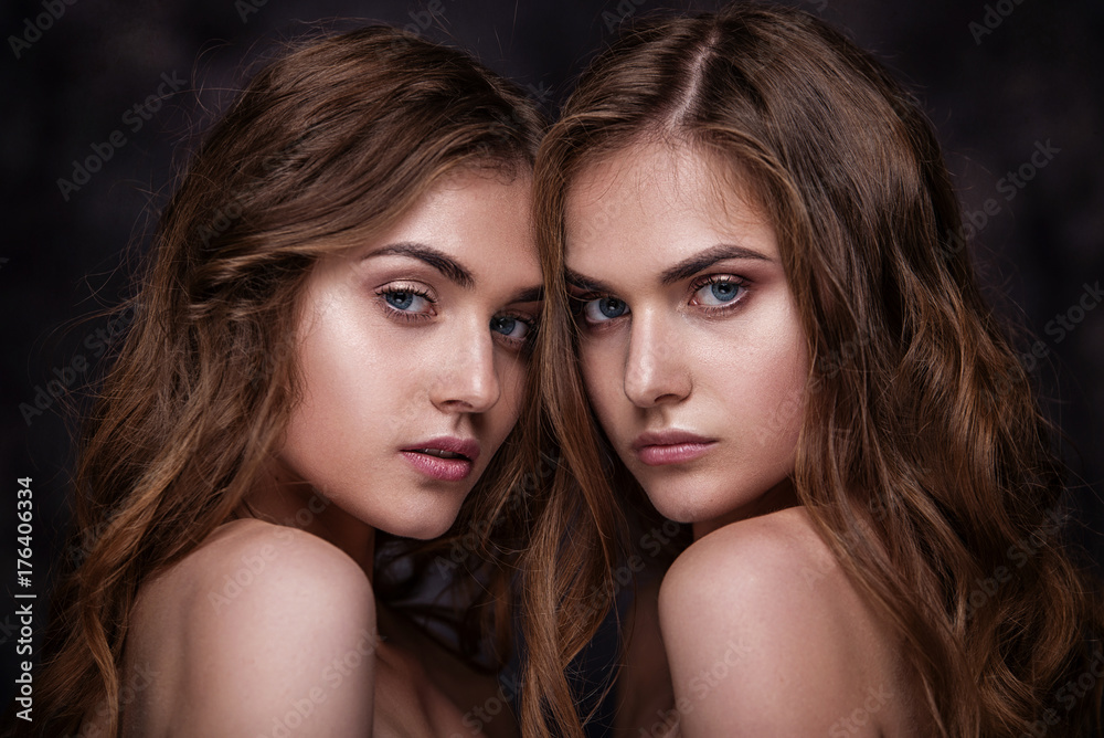 Fashion studio picture of two twins beautiful women. Close-up be Fashion studio picture of two twins beautiful women. Close-up be