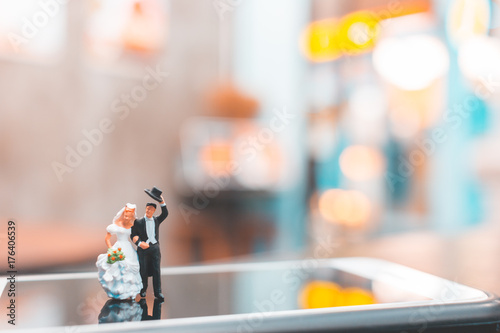 Miniature people   Couple standing on smartphone   love concept