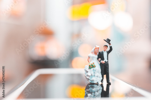 Miniature people   Couple standing on smartphone   love concept