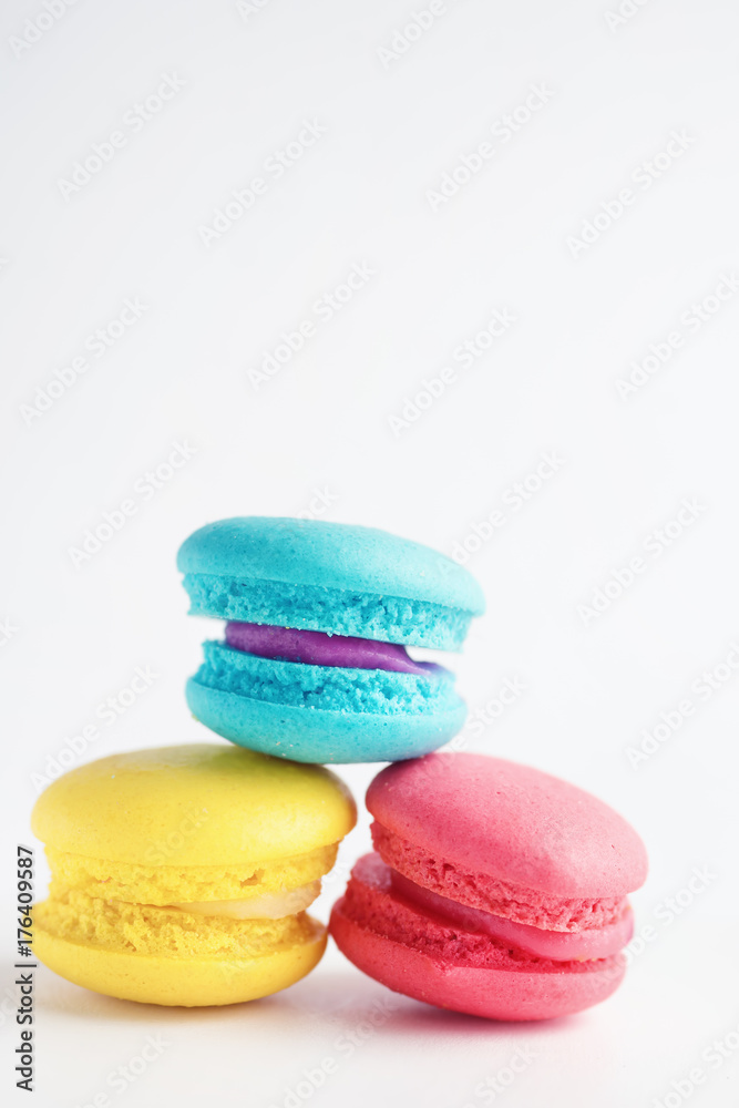 stack of Vibrant colorfull macarons on white wooden table. Text space stack of Vibrant colorfull macarons on white wooden table. Text space