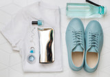 Casual fashion style shoes flat lay with woman's accessories and a bottle of water. Top view
