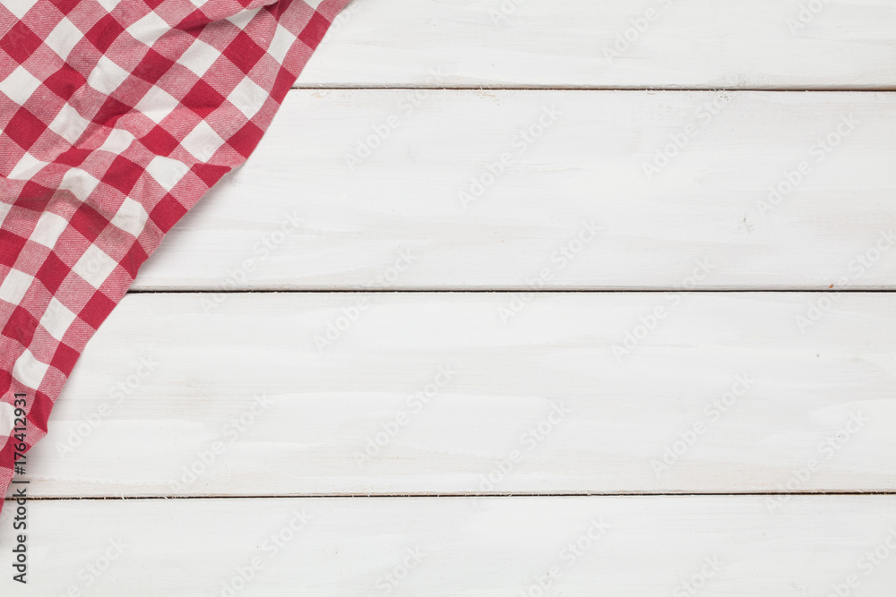 Obraz premium Textile napkin on a wooden background. Edge. View from above. For your design.