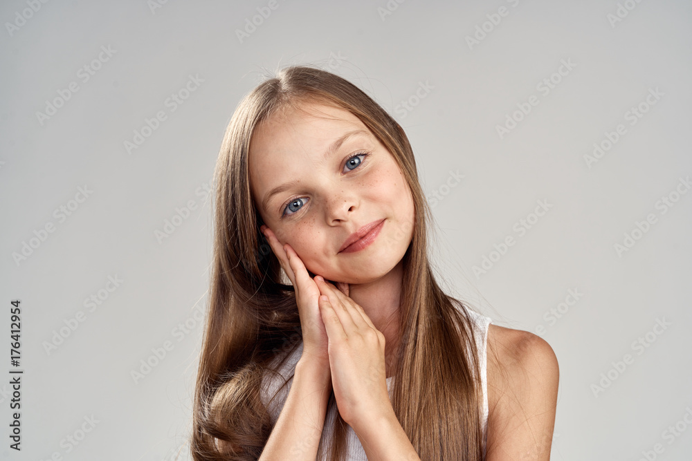 little girl with long hair on a light gray background, portrait little girl with long hair on a light gray background, portrait
