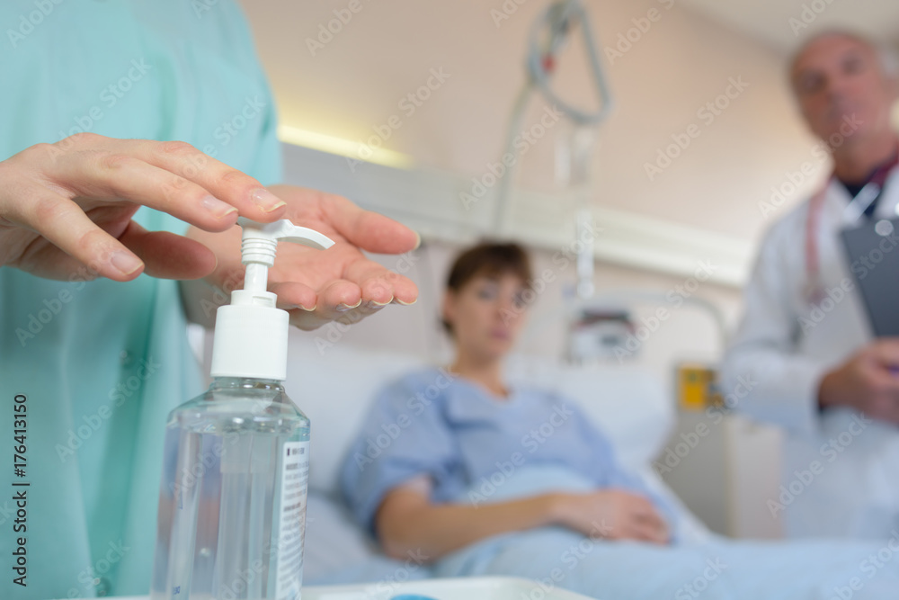 Nurse applying antibacterial gel to hands Nurse applying antibacterial gel to hands