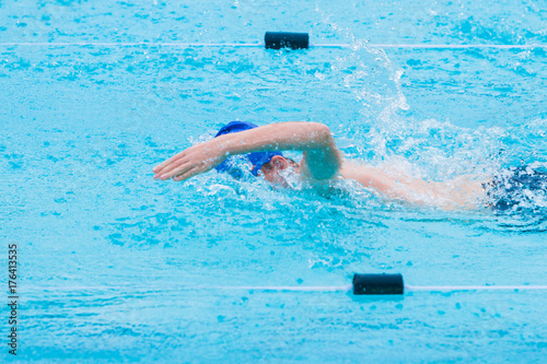 male swimmer swimming freestyle stroke in a swimming pool