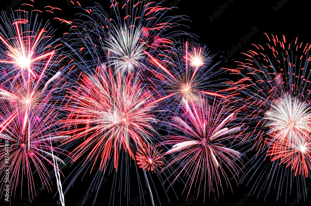 Amazing blue, white and red fireworks on dark background