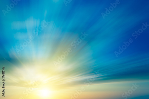 Gently-blue sky, clouds and sunset over the horizon.