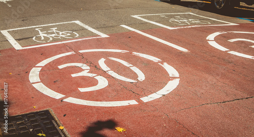 Canvas Print white paint on a red road indicating presence of a bicycle and forbidden to exce