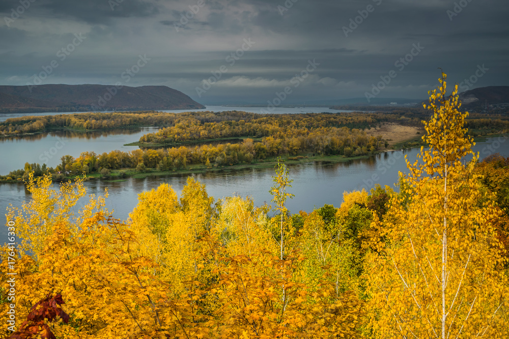 yellow autumn trees on hill in front of Volga river