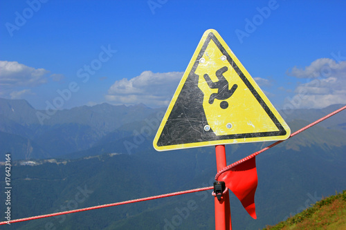 Caution sign might drop from cliff