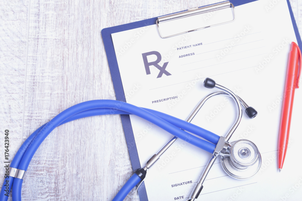 Closeup of medical stethoscope on a rx prescription Closeup of medical stethoscope on a rx prescription