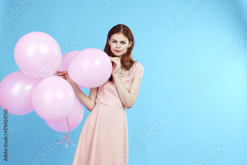 1655508 woman and balloons on a blue background