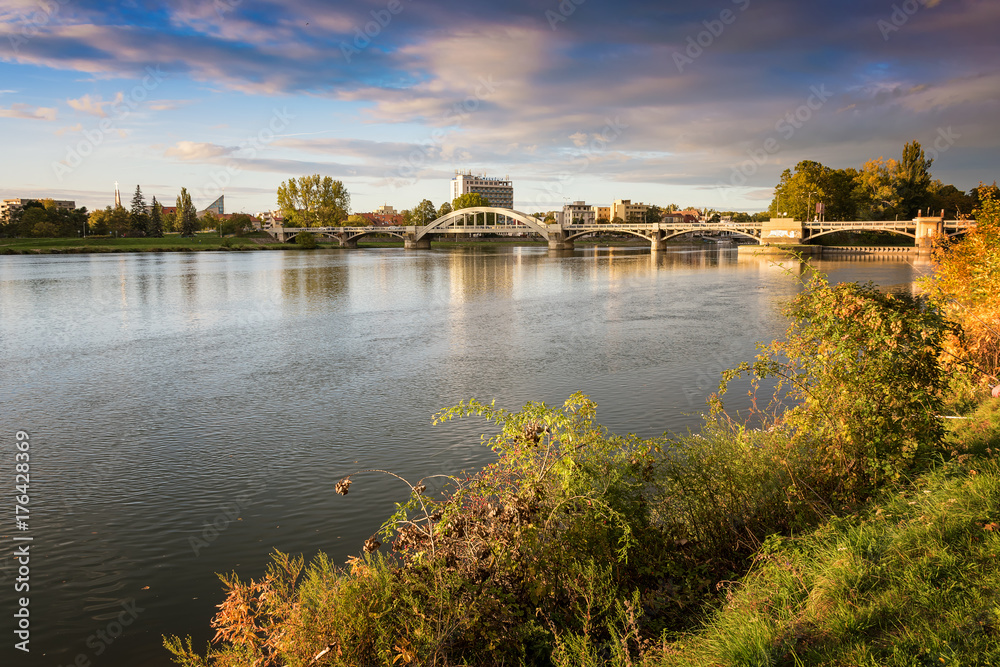 Fototapeta premium Bridge in Piestany (Slovakia), dark sky + colorful autumn