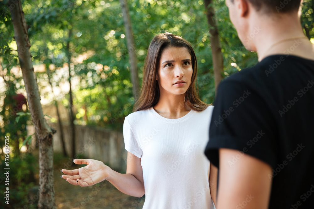 Confused young woman gesturing with hand Confused young woman gesturing with hand