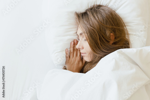 Woman is sleeping in the bed