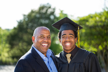 Father hugging his son at his graduation.