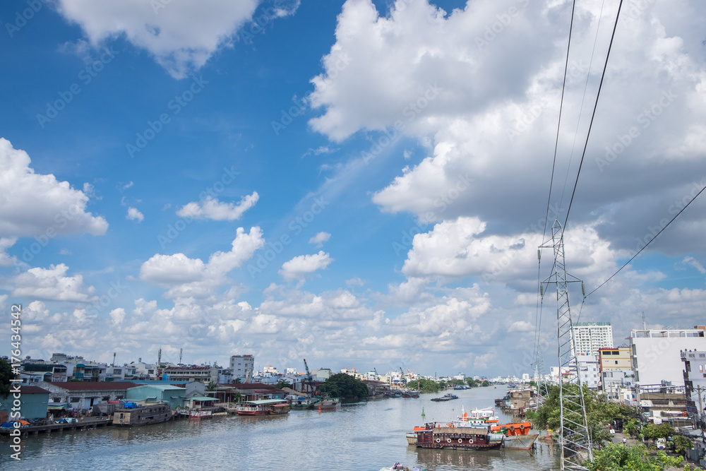 View from a bridge of Ho Chi Minh City to the river with boats. Wooden boats are the transportation on the river