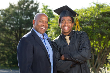 Father hugging his son at his graduation.
