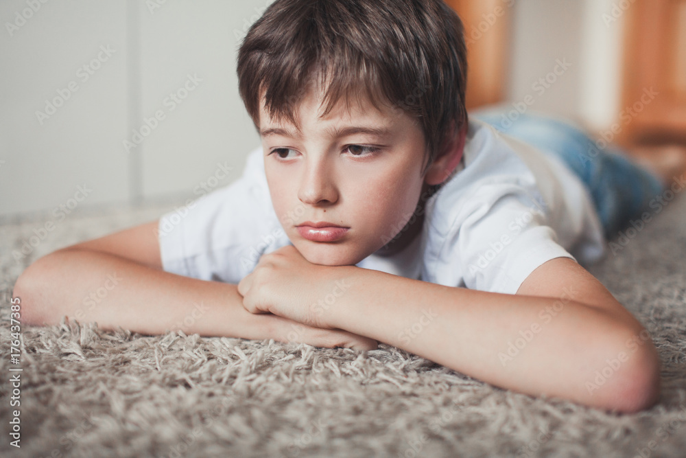 Young boy laying upset on the floor Stock Photo Adobe Stock