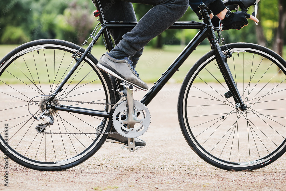 Detail of bicycle and ciclyst in the park