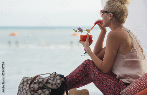 Woman Drinking a Coctkail at the Beach photo