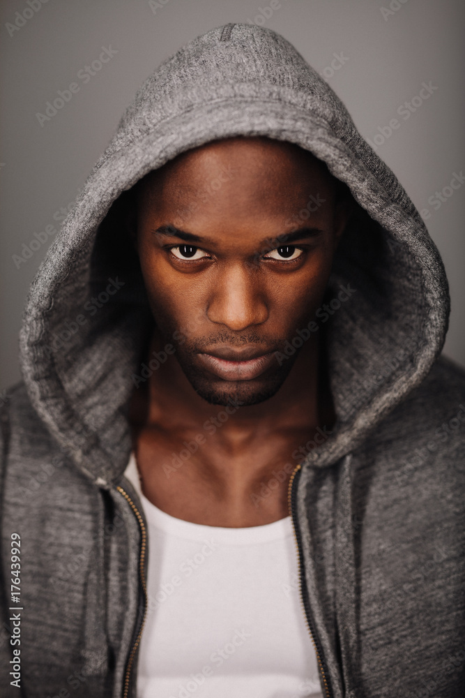 Serious young man in hooded sweatshirt Serious young man in hooded sweatshirt