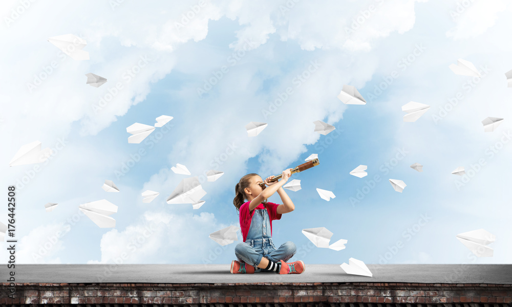 Concept of careless happy childhood with girl exploring this world