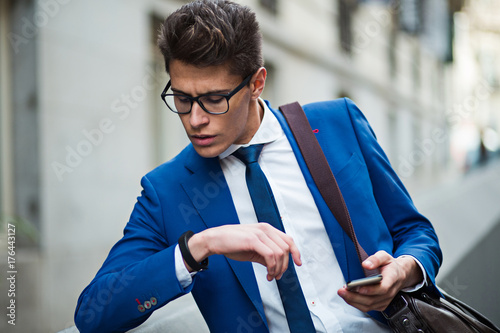 attractive businessman checking the time