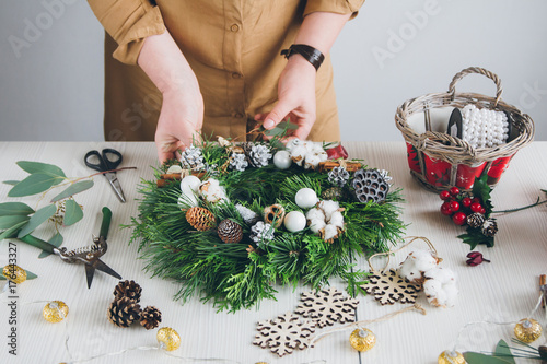 Florist decorator making Christmas wreath