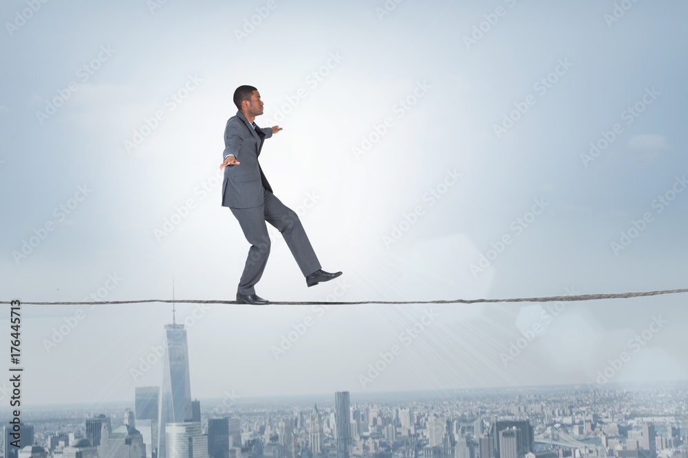 Composite image of businessman performing a balancing act Composite image of businessman performing a balancing act