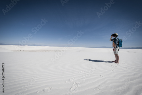 Woman looking binoculars. White Sands National Monument. New Mexico.