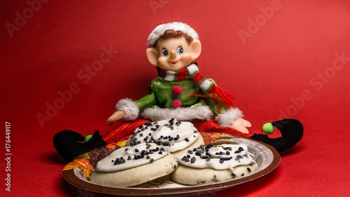 Christmas elf sits down to a plate of Thanksgiving goodies.