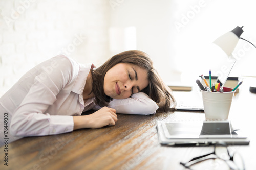 Tired woman sleeping on her desk