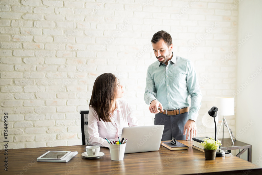Boss giving feedback to his new employee Stock Photo | Adobe Stock