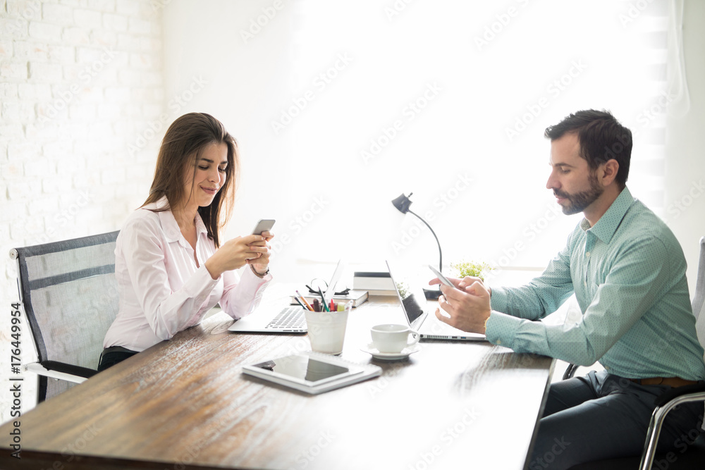 Coworkers distracted by technology Coworkers distracted by technology