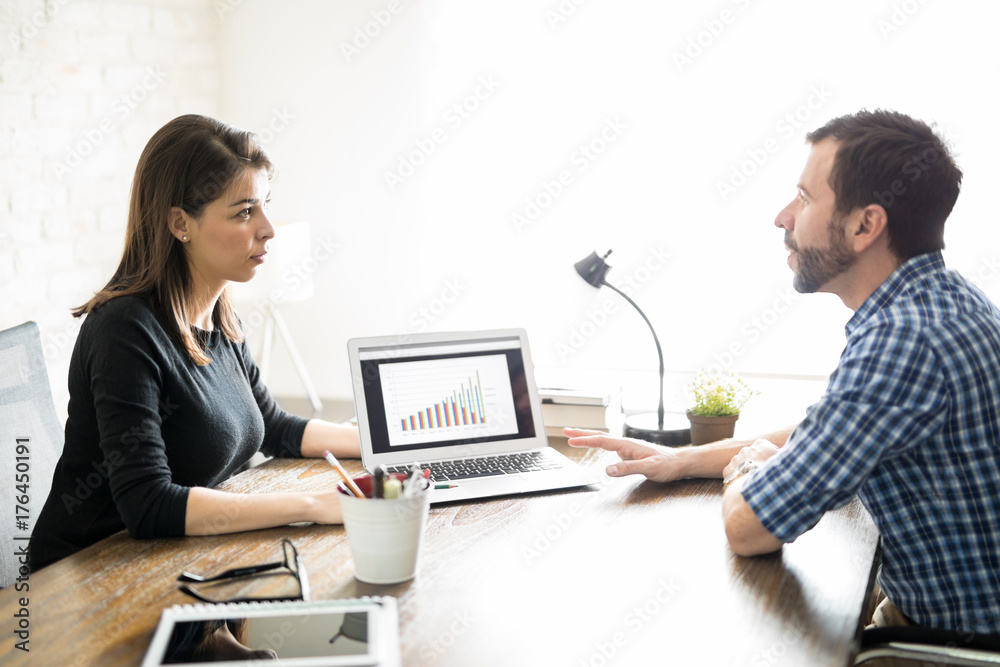 Woman showing sales report to a client