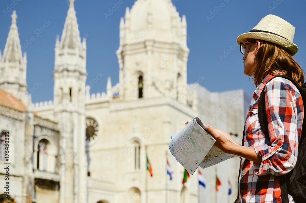 Close up detail of tourist traveler hands holding city map on sunny day outdoors background. Person having fun exploring abstract landmark tourism lifestyle