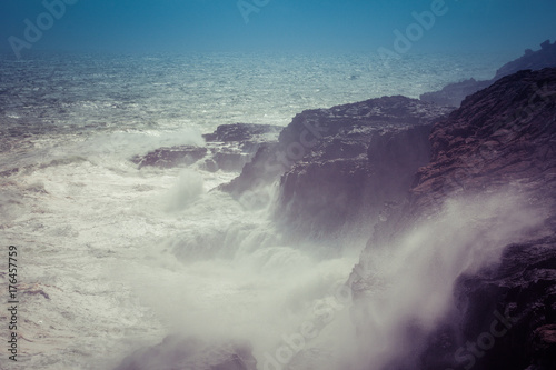 Waves breaking hard on rocks - extreme force of nature.