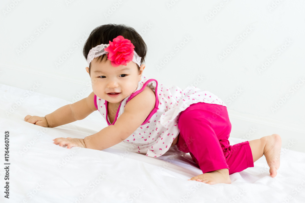 Portrait of adorable baby sliding on a sloped floor with head band Portrait of adorable baby sliding on a sloped floor with head band