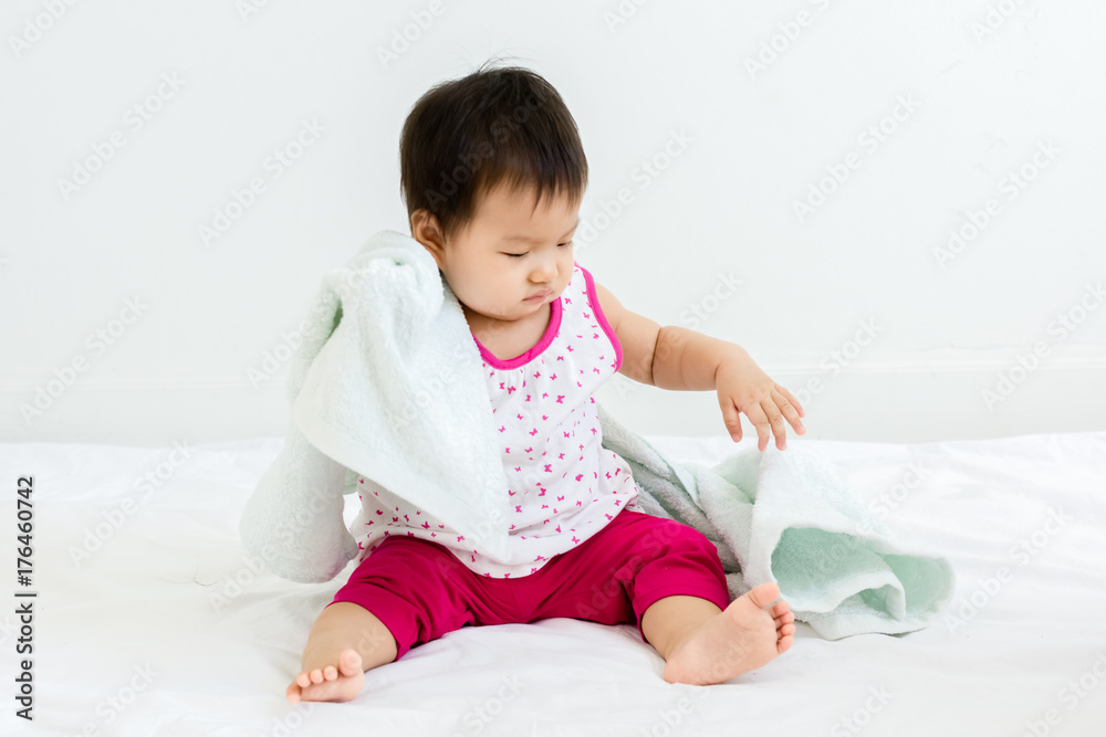 Portrait of adorable baby sitting with towel, indoors Portrait of adorable baby sitting with towel, indoors