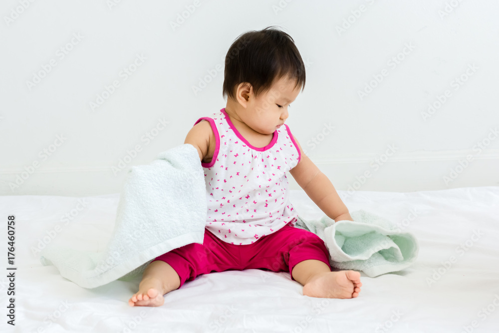 Portrait of adorable baby sitting with towel, indoors Portrait of adorable baby sitting with towel, indoors
