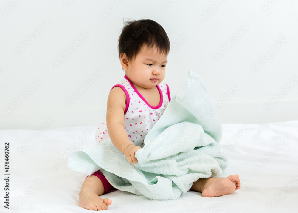 Portrait of adorable baby sitting with towel, indoors Portrait of adorable baby sitting with towel, indoors