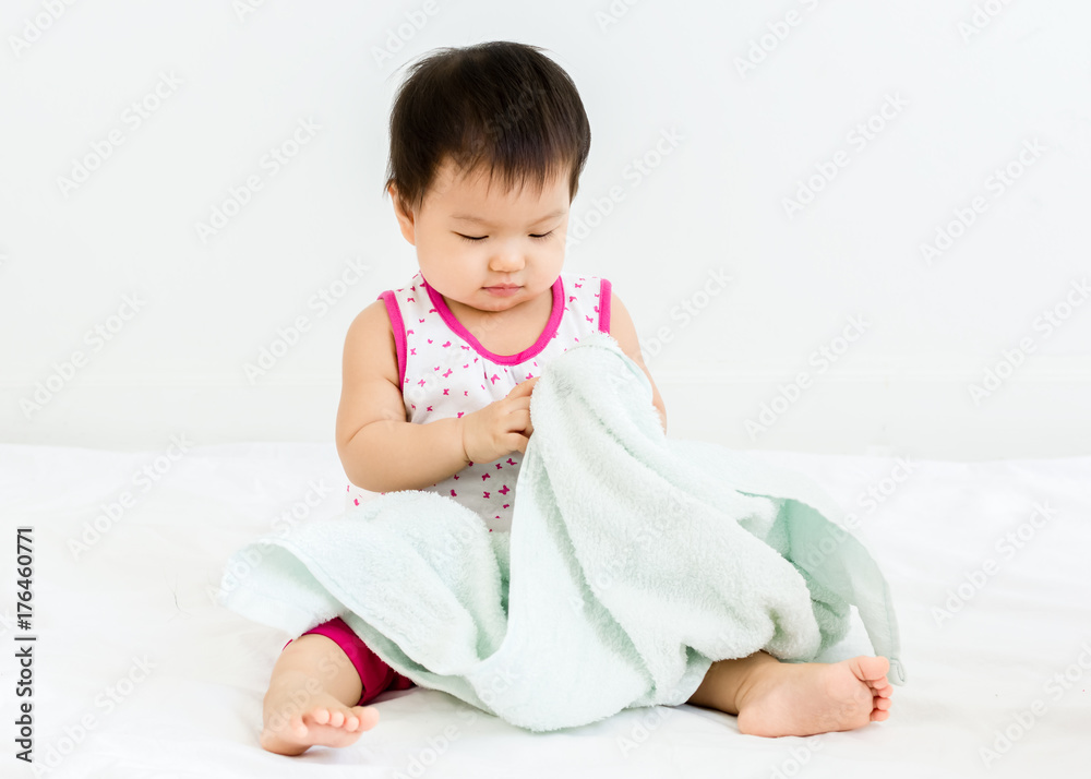 Portrait of adorable baby sitting with towel, indoors Portrait of adorable baby sitting with towel, indoors