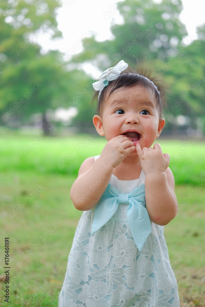 Asian Adorable baby girl playing in park. Beautiful smiling cute baby Asian Adorable baby girl playing in park. Beautiful smiling cute baby