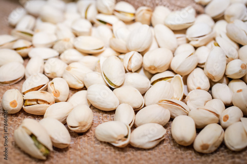 Roasted and salted pistachios in shell (texture, background)