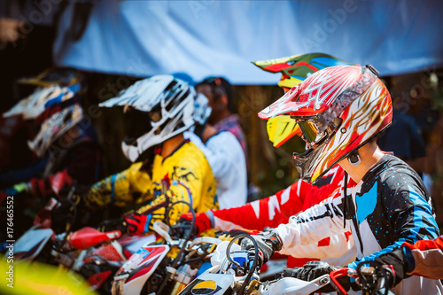 Close-up of biker sitting on motorcycle in starting point before the start of the race